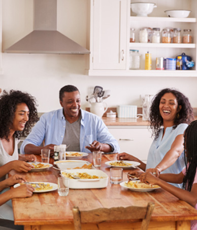 Family eating dinner at kitchen table