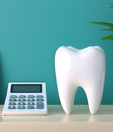 Tooth model sitting next to calculator