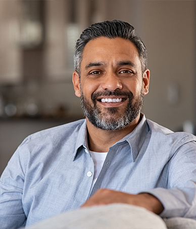 Smiling man sitting on couch