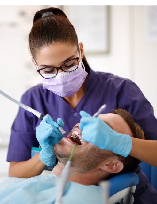 Dental team member treating a patient