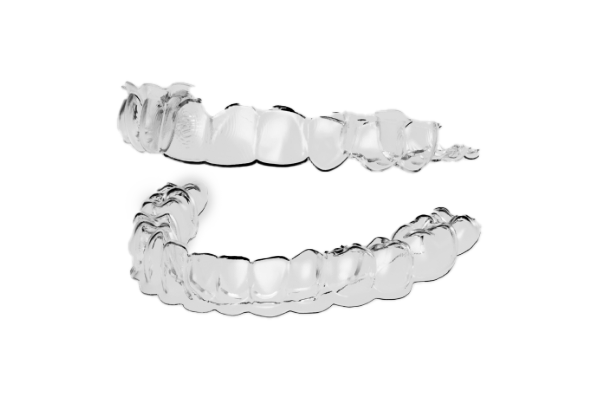 Two clear aligners against white background