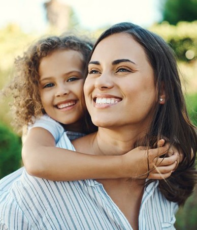 Smiling mom and child walking outdoors