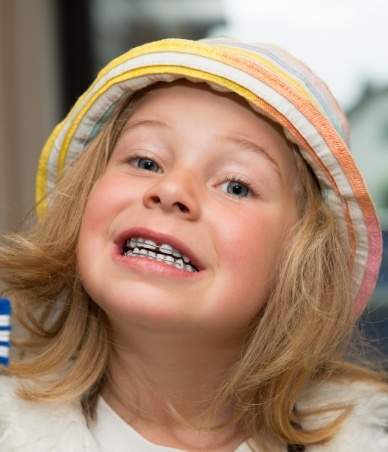 Young girl grinning with braces