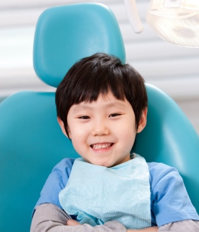 Young boy smiling in dental chair