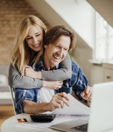 Man and woman looking at laptop together