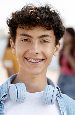 Teenage boy smiling with traditional braces