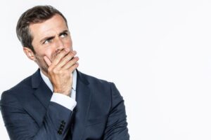 Concerned man covering his mouth 